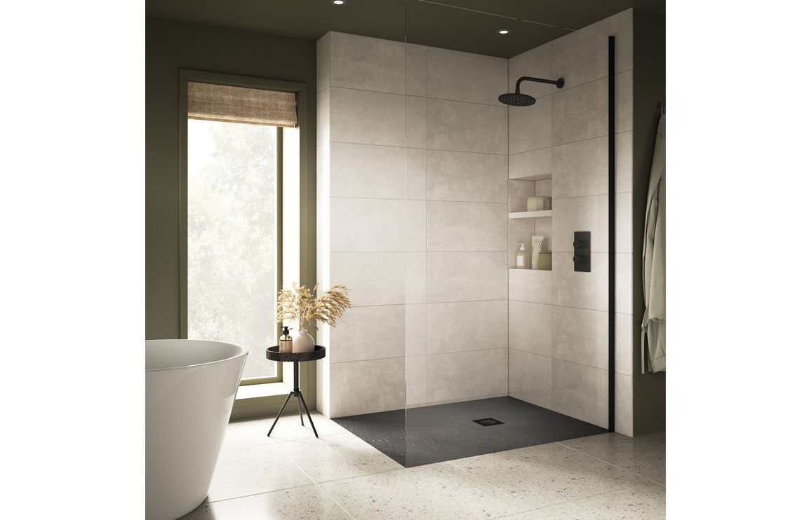 Modern bathroom with slate grey shower tray and dark grey stainless steel shower door, featuring a white wall and black floor tiles.