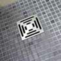 mosaic tiled tray close up of stainless steel drain grid