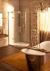 Luxurious bathroom with a freestanding bathtub, shower enclosure, and chandelier.