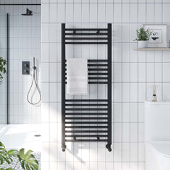 black towel radiator on white tiles