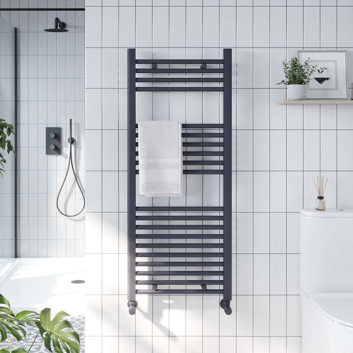 anthracite towel radiator on white tiled wall