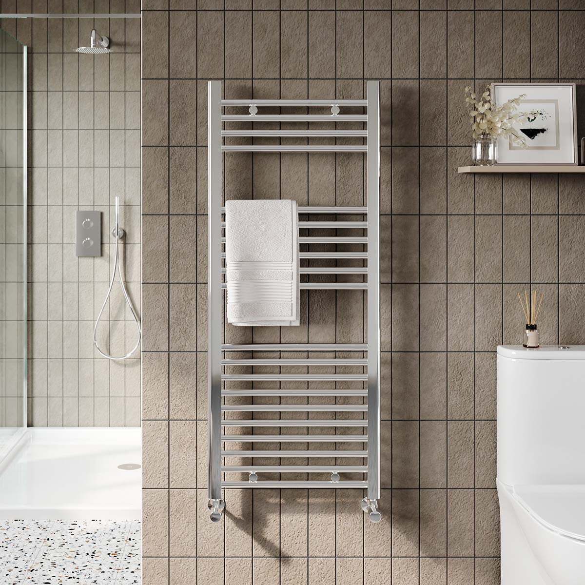 Chrome towel radiator on stone tiles